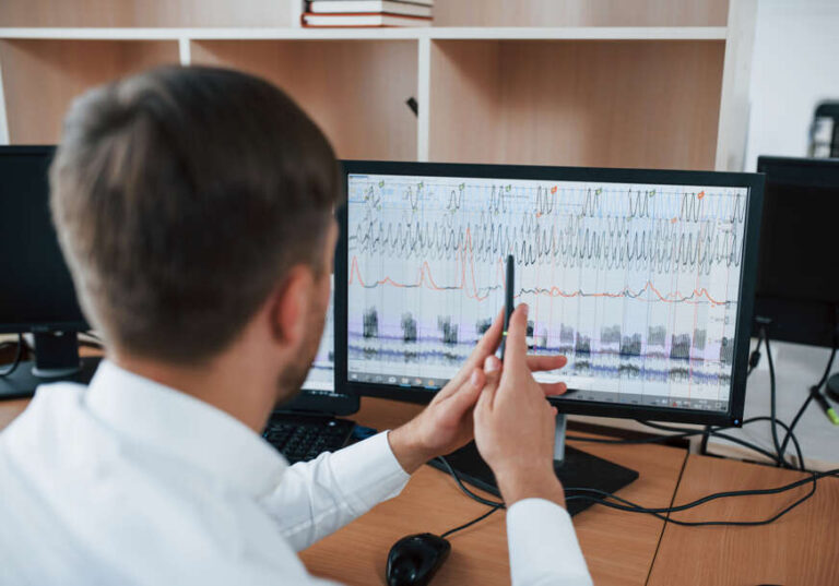 Working process. Polygraph examiner in the office with his lie detector's equipment